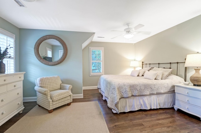 bedroom with ceiling fan and dark hardwood / wood-style flooring