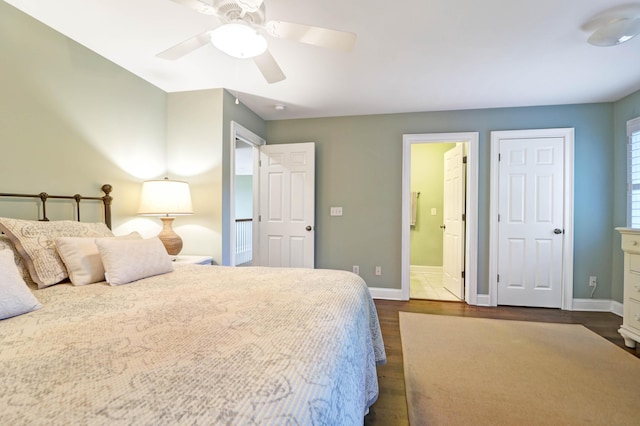 bedroom featuring dark hardwood / wood-style flooring, connected bathroom, and ceiling fan