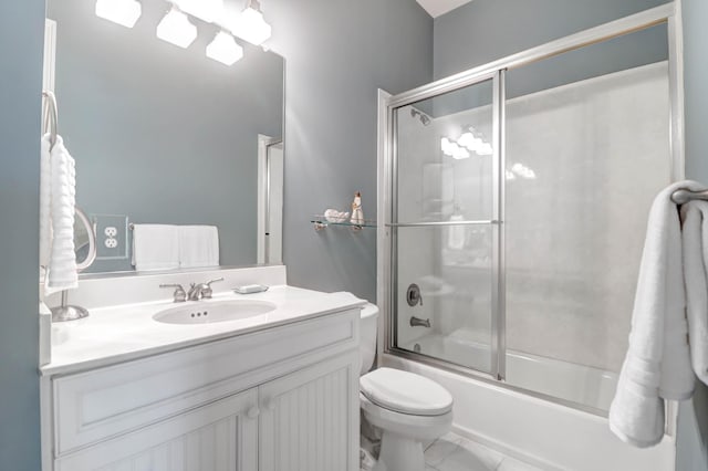 full bathroom featuring vanity, shower / bath combination with glass door, and toilet