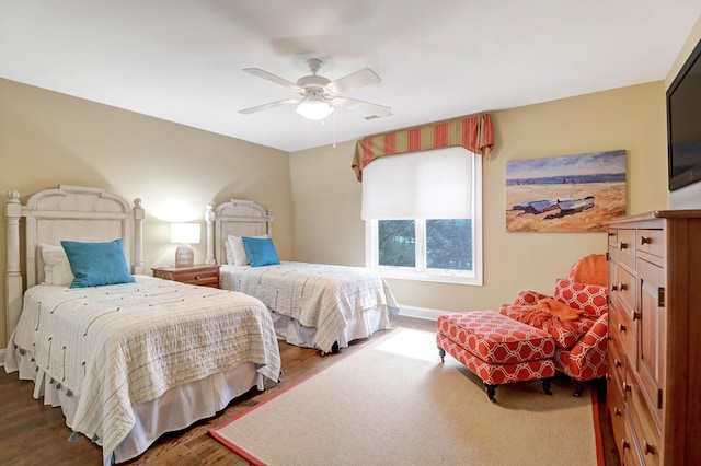 bedroom with dark hardwood / wood-style floors and ceiling fan