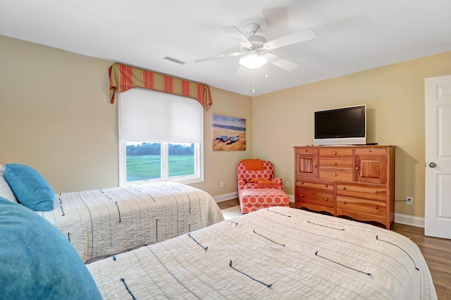 bedroom with dark wood-type flooring and ceiling fan