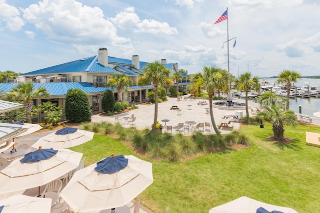 view of property's community featuring a water view and a lawn