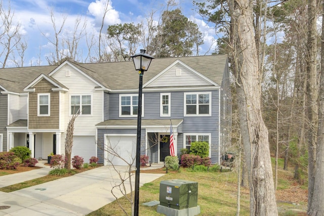 127 Rosefield Ct, Summerville, SC 29485 - townhome / multi-family property featuring concrete driveway, a garage, roof with shingles, and a chimney