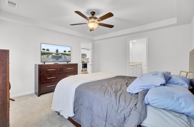 127 Rosefield Ct, Summerville, SC 29485 - bedroom with visible vents, baseboards, light colored carpet, a tray ceiling, and ensuite bath