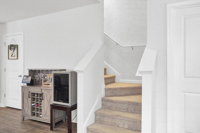 127 Rosefield Ct, Summerville, SC 29485 - staircase with beverage cooler, a bar, and wood finished floors