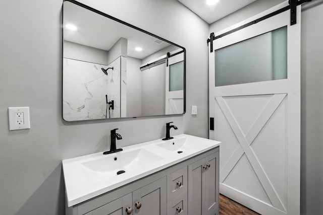 bathroom featuring vanity, wood-type flooring, and walk in shower