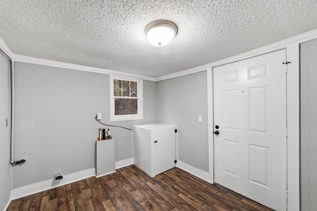 clothes washing area featuring dark hardwood / wood-style flooring, ornamental molding, and a textured ceiling