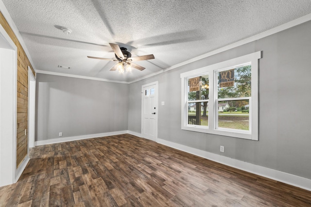 empty room featuring dark hardwood / wood-style floors, ceiling fan, crown molding, and a textured ceiling