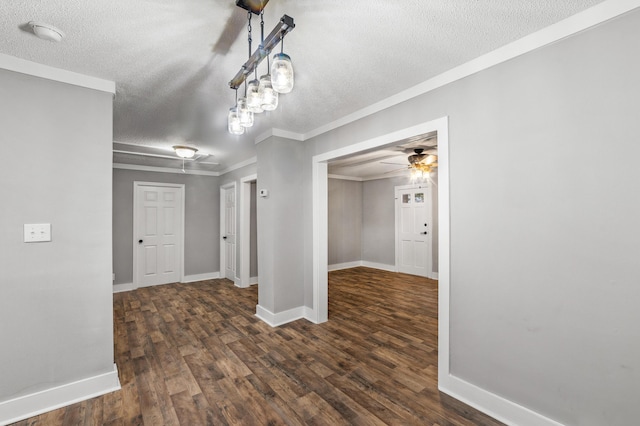 unfurnished dining area with crown molding, ceiling fan, dark hardwood / wood-style flooring, and a textured ceiling