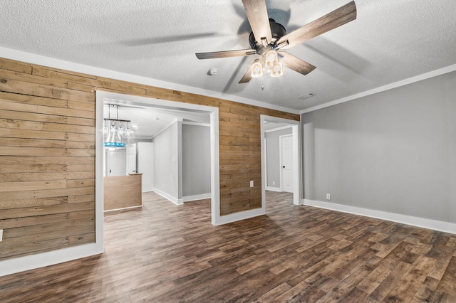 unfurnished bedroom featuring ceiling fan, wood walls, dark hardwood / wood-style flooring, and a textured ceiling