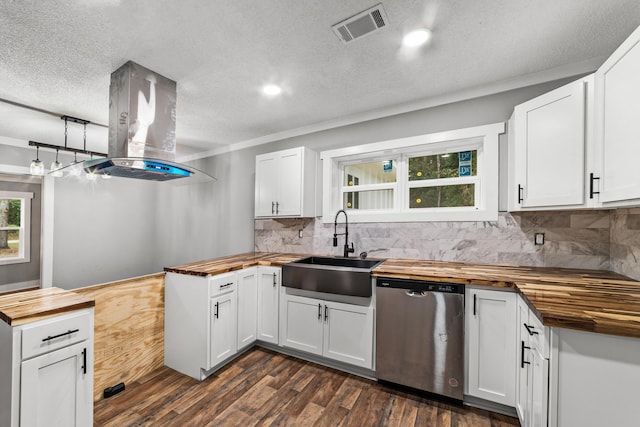 kitchen with butcher block countertops, dishwasher, and white cabinets