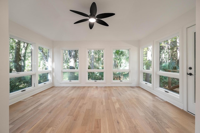 unfurnished sunroom featuring ceiling fan