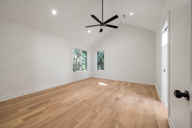 spare room with ceiling fan, lofted ceiling, and light hardwood / wood-style flooring