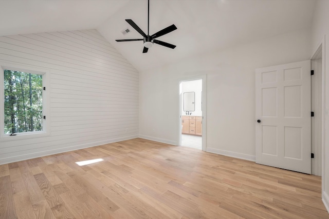 unfurnished room with ceiling fan, high vaulted ceiling, and light hardwood / wood-style flooring