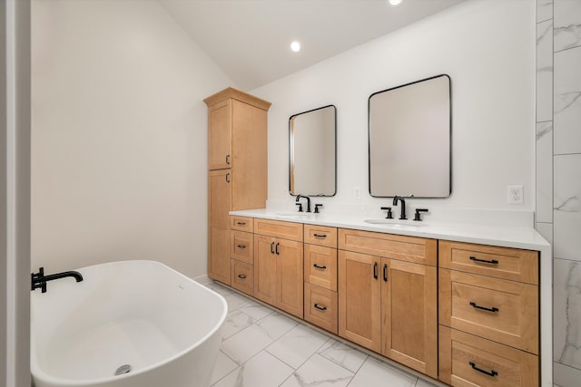 bathroom with a bathing tub, vanity, and vaulted ceiling