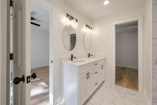 bathroom featuring hardwood / wood-style floors, vanity, and ceiling fan