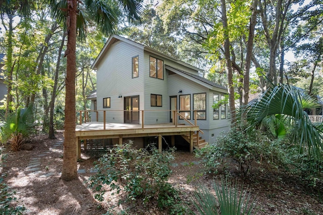 rear view of property featuring a wooden deck