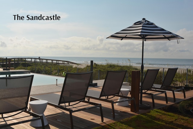 wooden terrace with a beach view and a water view