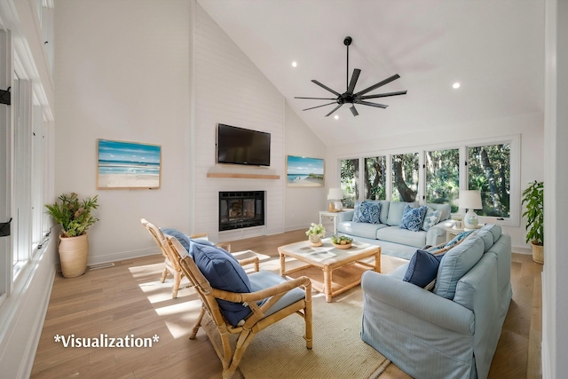 living room with ceiling fan, light hardwood / wood-style floors, a fireplace, and high vaulted ceiling