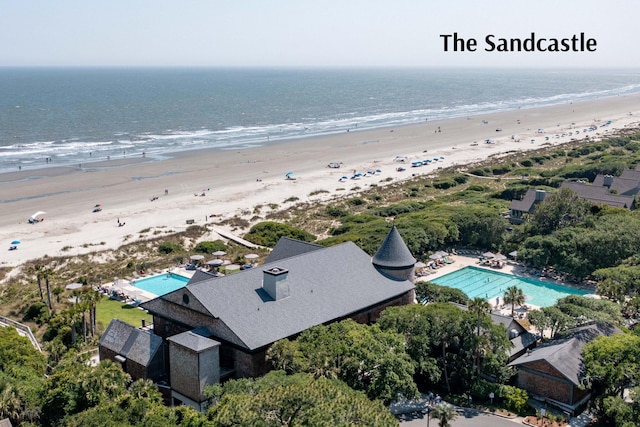 bird's eye view with a water view and a beach view