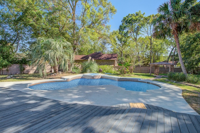 view of pool featuring a deck and an in ground hot tub