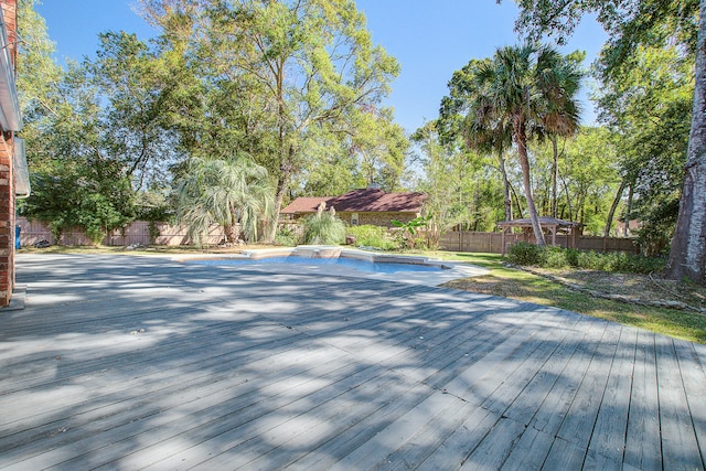 view of swimming pool with a wooden deck