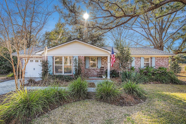 ranch-style house featuring a garage and a front lawn