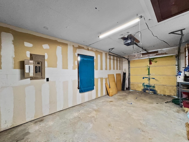 garage with a garage door opener and electric panel