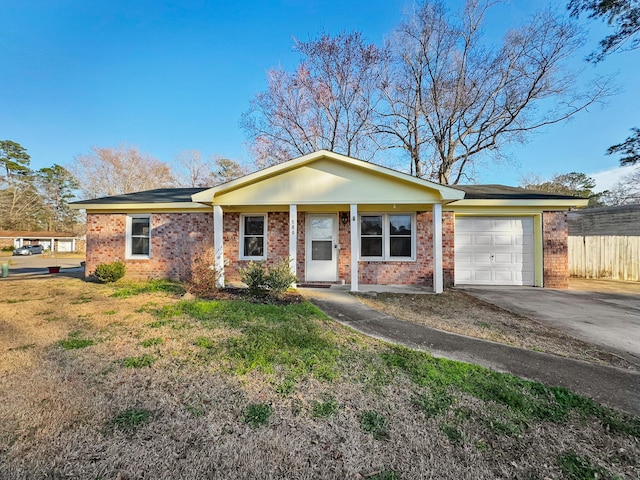 single story home with a garage, brick siding, fence, driveway, and a front lawn