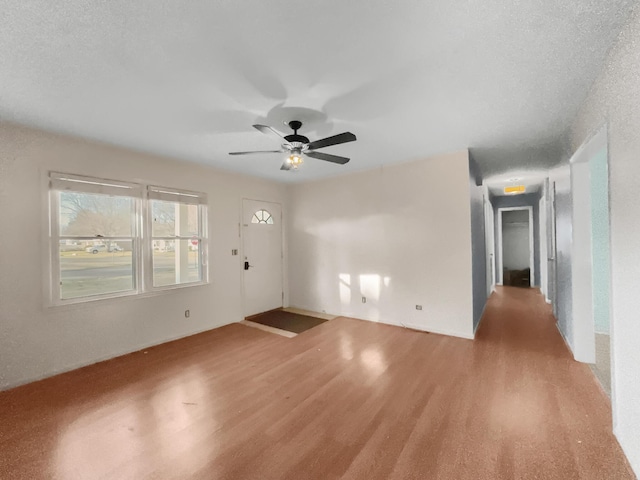 spare room with ceiling fan and wood finished floors