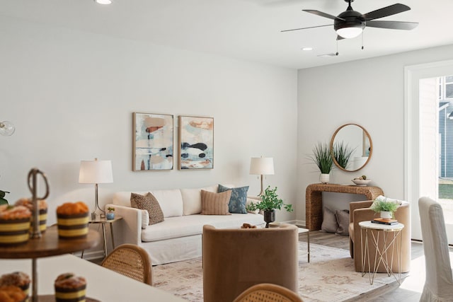 living room with ceiling fan and light wood-type flooring