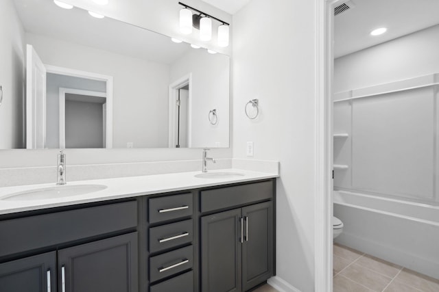 full bathroom with vanity,  shower combination, tile patterned floors, and toilet