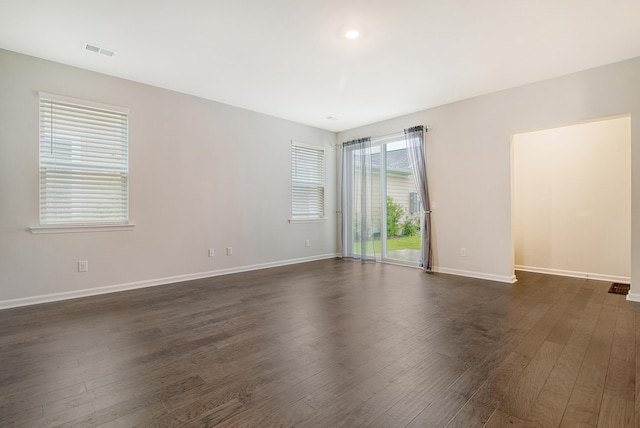 unfurnished room featuring dark wood-type flooring