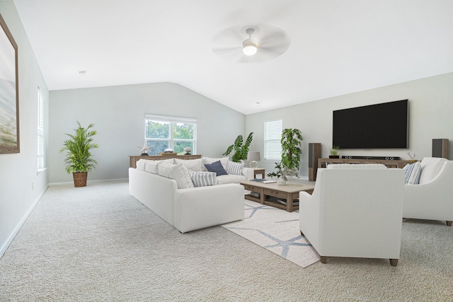 carpeted living room with ceiling fan and vaulted ceiling