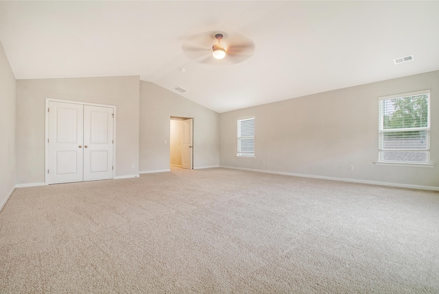 unfurnished bedroom with multiple windows, ceiling fan, a closet, and light colored carpet