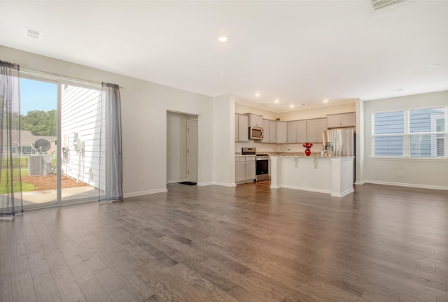 unfurnished living room with dark hardwood / wood-style flooring