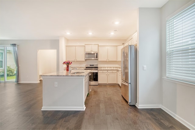 kitchen featuring light stone countertops, sink, dark wood-type flooring, white cabinets, and appliances with stainless steel finishes