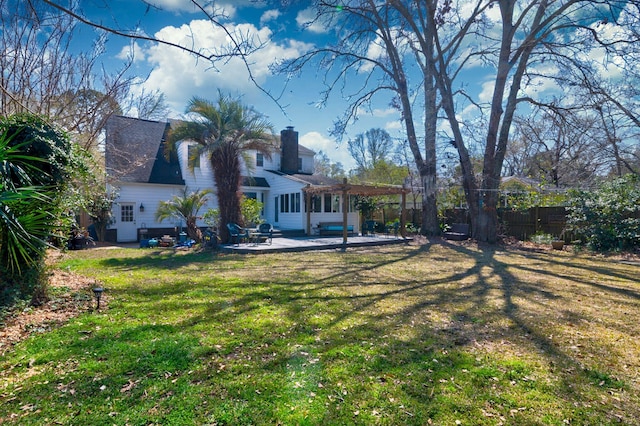 back of house with a patio, fence, roof with shingles, a yard, and a pergola