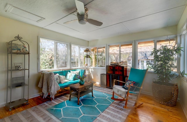 sunroom featuring ceiling fan