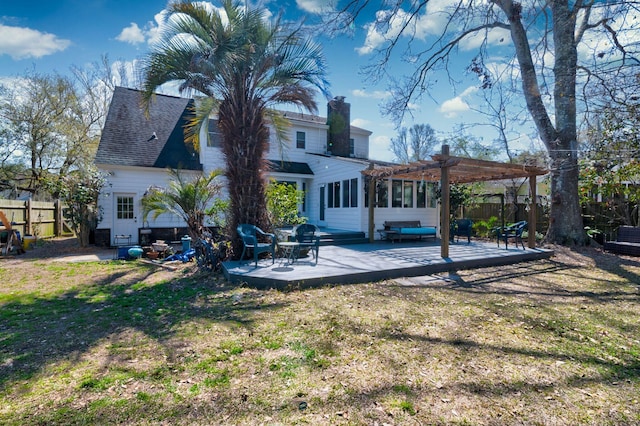 back of property featuring a lawn, a pergola, fence, roof with shingles, and a patio area