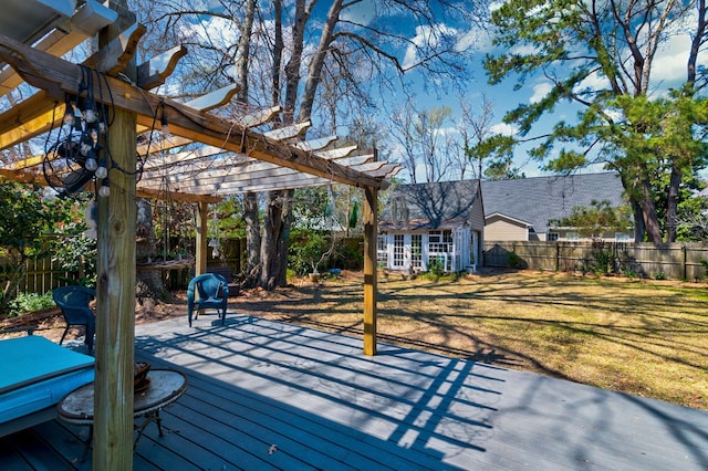 wooden terrace featuring a yard, an outbuilding, a fenced backyard, and a pergola