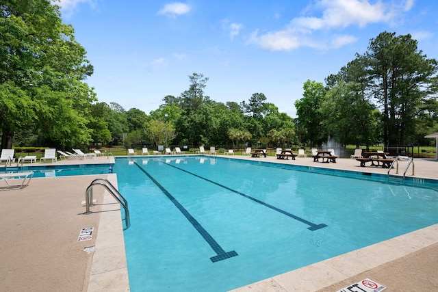 view of swimming pool featuring a patio area