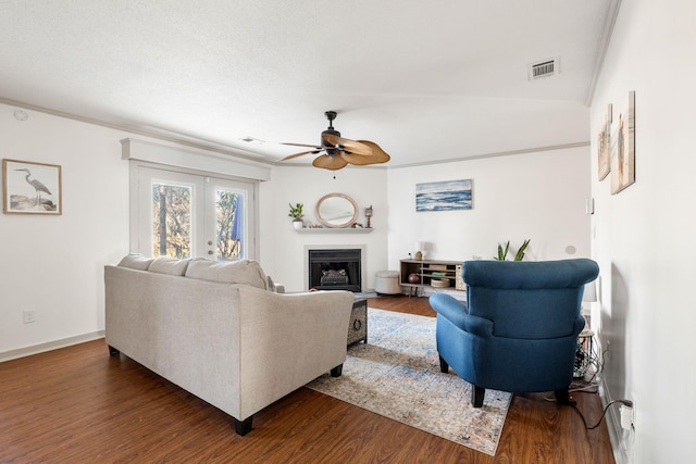 living room with dark hardwood / wood-style flooring, ceiling fan, and crown molding