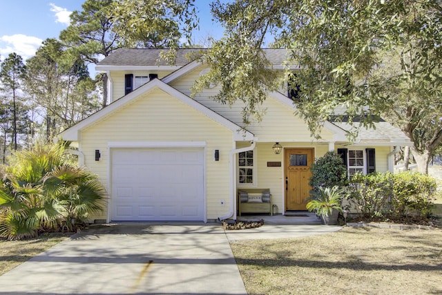 view of front of property with an attached garage, concrete driveway, and roof with shingles