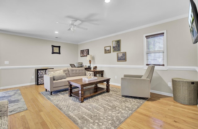 living room featuring baseboards, ceiling fan, wood finished floors, crown molding, and recessed lighting