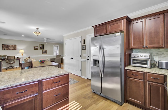 kitchen with stainless steel fridge, visible vents, decorative backsplash, light wood-style flooring, and crown molding