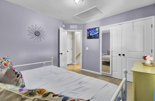 bedroom featuring carpet floors, a closet, visible vents, attic access, and baseboards