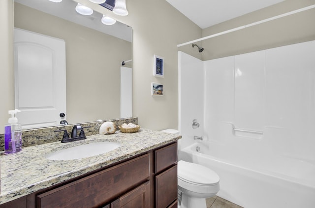 bathroom featuring shower / washtub combination, tile patterned flooring, vanity, and toilet