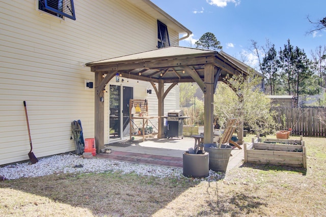 view of patio / terrace featuring a gazebo, a grill, and fence