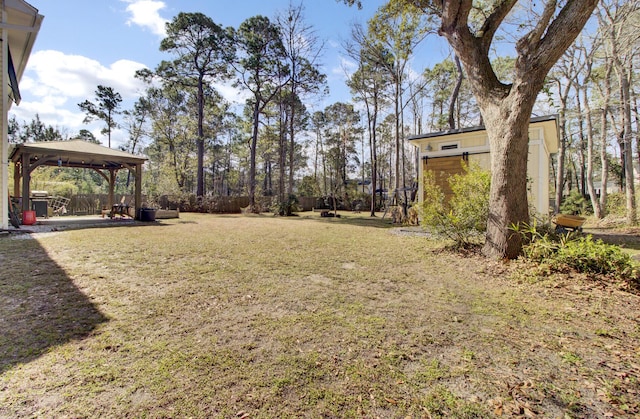 view of yard with fence and a gazebo